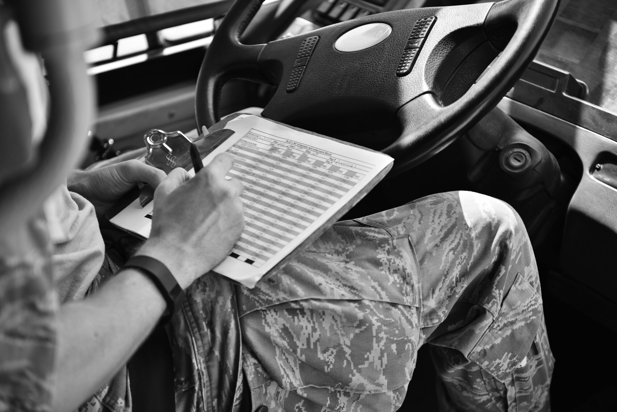 Senior Airman Daniel Wensel, 379th Expeditionary Logistics Readiness Squadron, annotates his arrival time to every stop during his shift operating a base shuttle for deployed members June 30, 2015 at Al Udeid Air Base, Qatar. The airmen from the 379th ELRS provide public transportation to over 2,500 deployed members from all services and branches on a daily basis to alleviate traffic and provide transportation to living quarters, dining facilities and various work areas.  (U.S. Air Force photo/ Staff Sgt. Alexandre Montes)