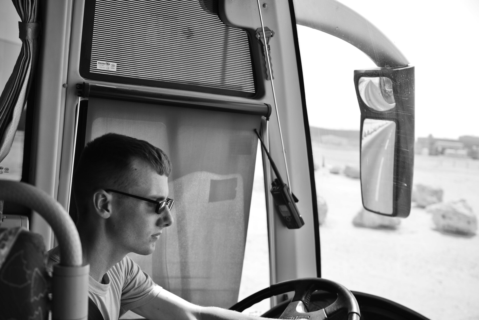 Senior Airman Daniel Wensel, Expeditionary Logistics Readiness Squadron, operates a base shuttle for deployed members June 30, 2015 at Al Udeid Air Base, Qatar. The airmen from the 379th ELRS provide public transportation to over 2,500 deployed members from all services and branches on a daily basis to alleviate traffic and provide transportation to living quarters, dining facilities and various work areas.  (U.S. Air Force photo/ Staff Sgt. Alexandre Montes)