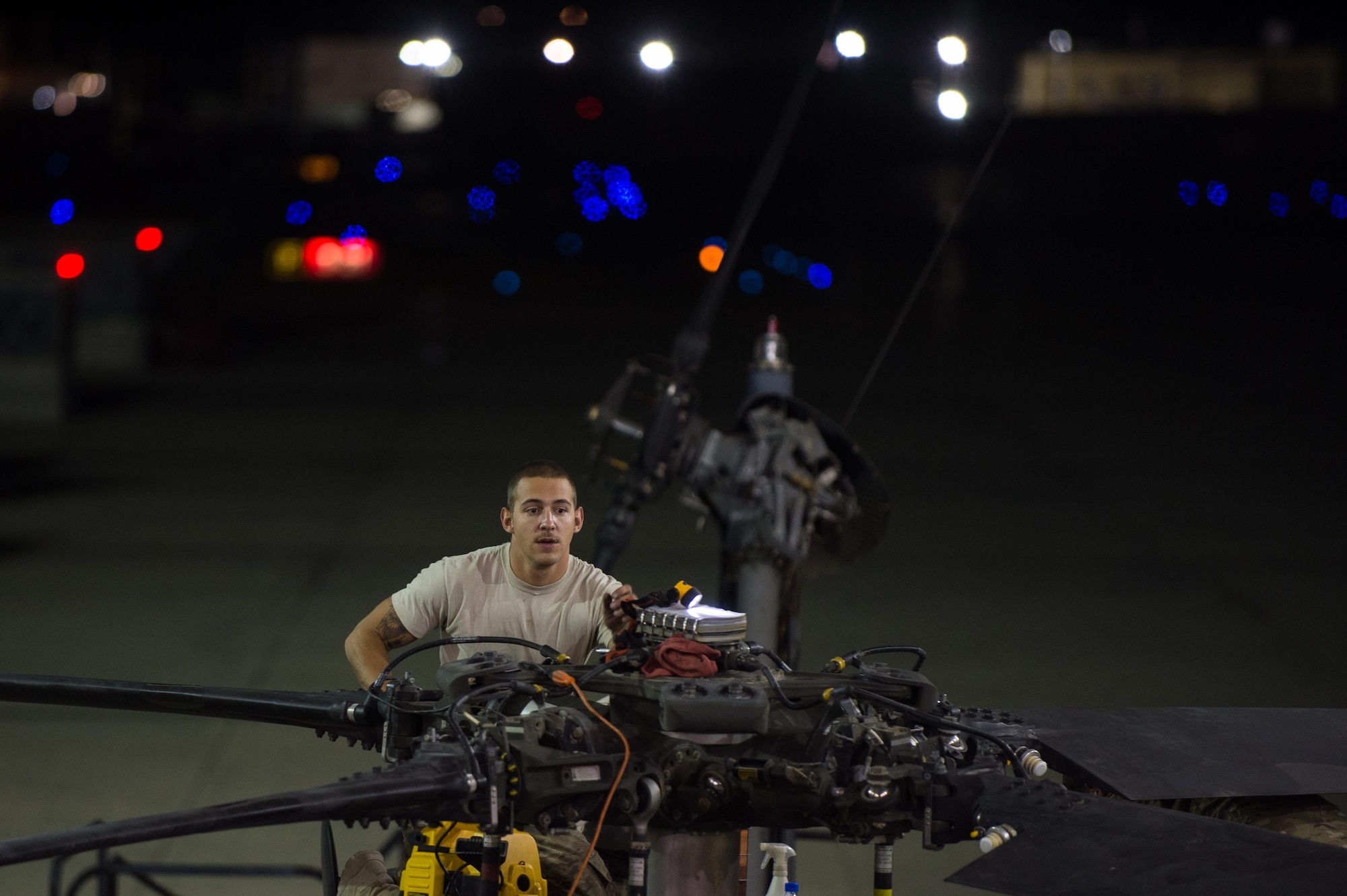 Airman Joshua Herron, a 41st Expeditionary Helicopter Maintenance Unit HH-60 Pave Hawk crew chief, completes a 50-hour inspection on a Pave Hawk at Bagram Airfield, Afghanistan, June 28, 2015. The 41st EHMU ensures Pave Hawks on Bagram Airfield are prepared for flight and returned to a mission-ready state once they land. (U.S. Air Force photo/Tech. Sgt. Joseph Swafford)