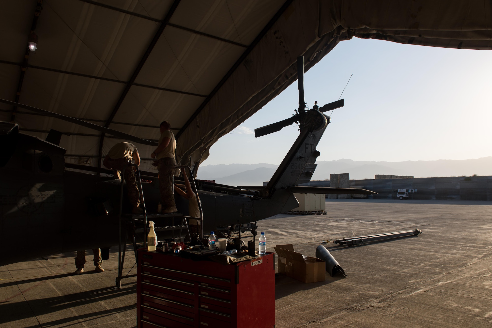 Airmen assigned to the 41st Expeditionary Helicopter Maintenance Unit work to complete a 50-hour inspection on a HH-60 Pave Hawk helicopter at Bagram Airfield, Afghanistan, June 28, 2015. The 41st EHMU ensures Pave Hawks on Bagram Airfield are prepared for flight and returned to a mission-ready state once they land. (U.S. Air Force photo/Tech. Sgt. Joseph Swafford)
