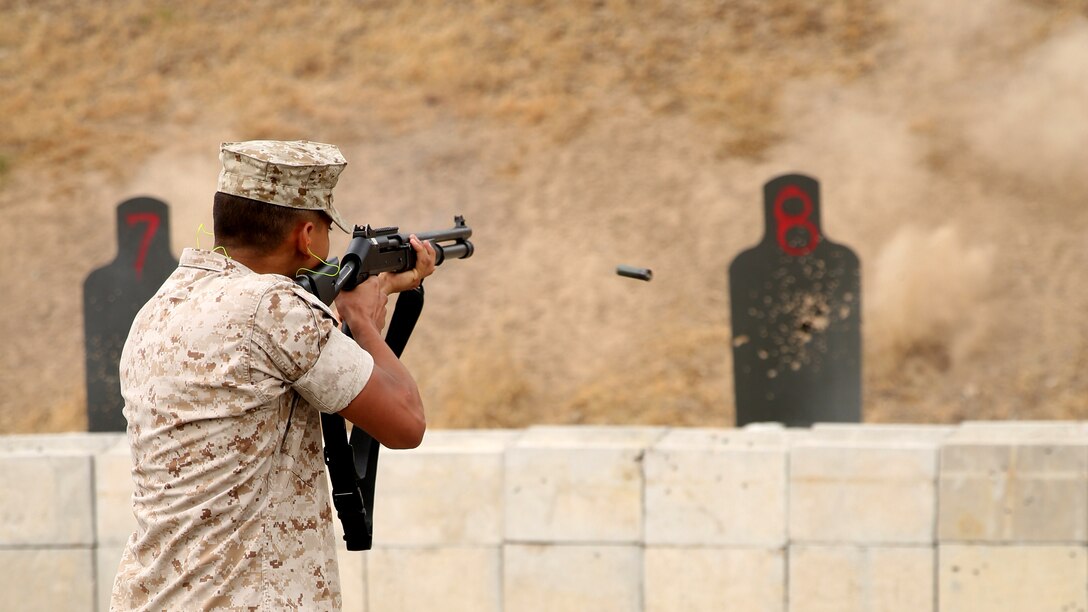 Lance Cpl. Raymond Guerrero, a technical controller with Headquarters and Headquarters Squadron and a Rio Hondo, Texas, native, shoots the M1014 shotgun during security augment force training at Marine Corps Air Station Miramar, California, June 30. SAF training is a two-week course that teaches service members arrest techniques and defensive tactics.