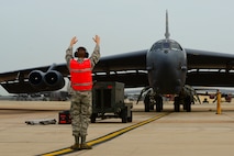 A B-52H Stratofortress is marshalled to a stop at Barksdale Air Force Base, La., after a 44-hour sortie July 2, 2015. Aircrew members and two B-52s from Barksdale’s 96th Bomb Squadron flew the round-trip mission to Australia where they integrated with Royal Australian Air Force ground forces in the region to conduct an exercise with inert conventional weapons and perform a low approach at RAAF Base Tindal. Long-duration bomber missions ensure aircrews maintain a high state of readiness and proficiency while demonstrating their ability to provide a flexible and always-ready global-strike capability in support of U.S. Strategic Command and geographic combatant commanders. (U.S. Air Force photo/Senior Airman Benjamin Raughton)