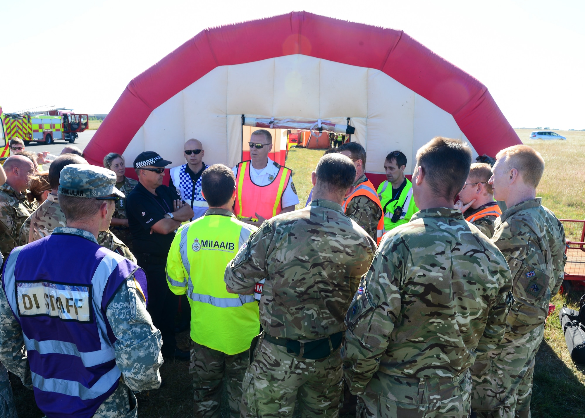Steven Kelly, 48th Civil Engineer Squadron fire chief, addresses personnel during exercise Diamond Dragon at Royal Air Force Honnington, England, June 30, 2015. Diamond Dragon is a three-day, joint forces response exercise that readies members of the U.K. Ministry of Defense, emergency response agencies and the U.S. Air Force for incidents that require help from both nations. (U.S. Air Force photo by Senior Airman Nigel Sandridge/Released)