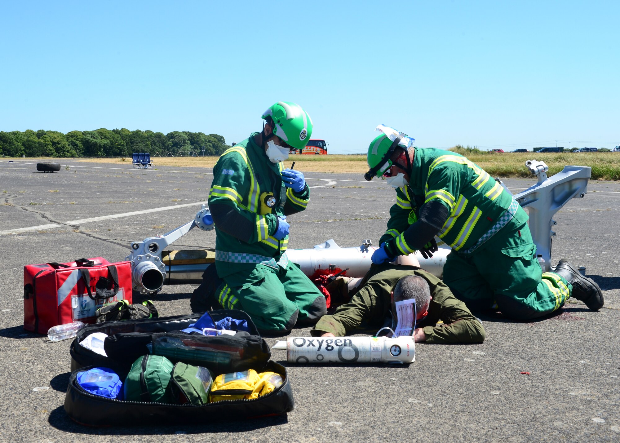 Suffolk Emergency Services provide first aid to mock plane crash victims during exercise Diamond Dragon at Royal Air Force Honnington, England, June 30, 2015. Diamond Dragon is a three-day, joint forces response exercise that readies members of the U.K. Ministry of Defense, emergency response agencies and the U.S. Air Force for incidents that require help from both nations. (U.S. Air Force photo by Senior Airman Nigel Sandridge/Released)