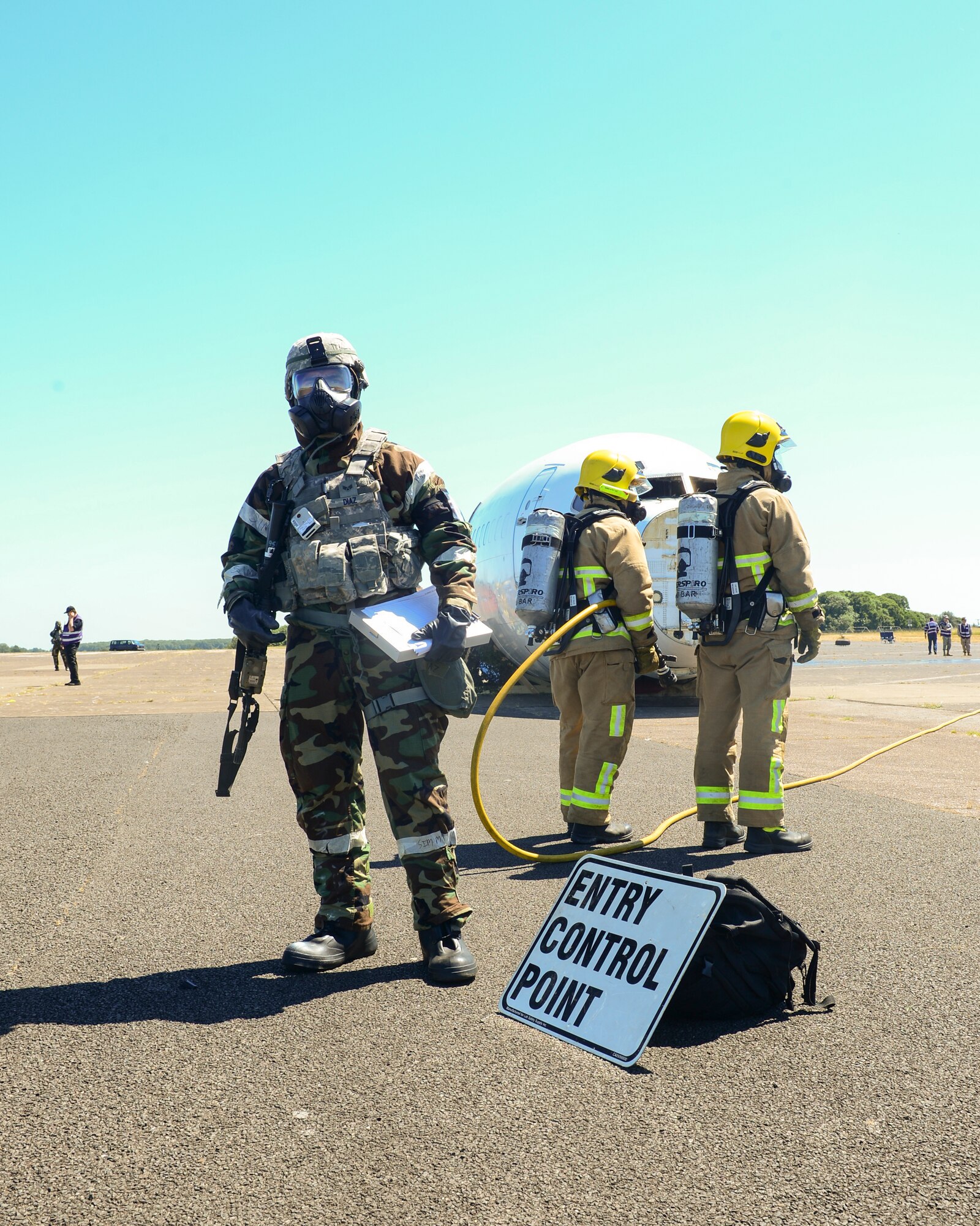 Senior Airman Nicolas Diaz, 48th Security Forces Squadron police services journeyman, sets up an entry control point during exercise Diamond Dragon at Royal Air Force Honnington, England, June 30, 2015. ECP’s are set in place during incidents to limit the amount of traffic through a crash scene. (U.S. Air Force photo by Senior Airman Nigel Sandridge/Released)