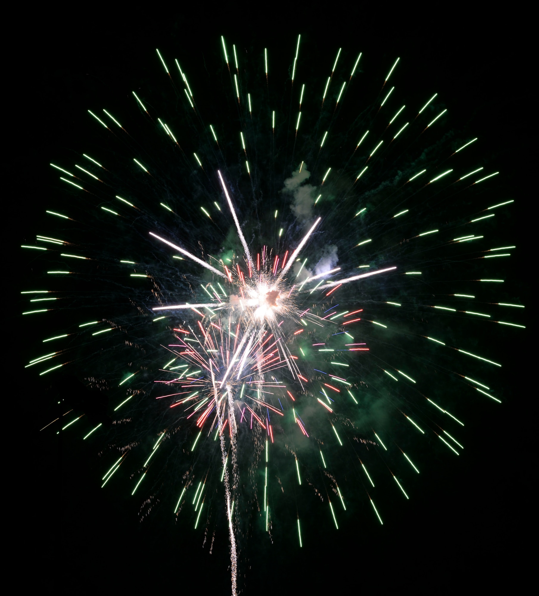 Fireworks bursting in air bring a close to the Freedom Fest Independence Day celebration at Holloman Air Force Base, N.M. July 2, 2015. Freedom Fest took place in the Domenici Fitness and Sports Center parking lot and included carnival games, rides, and live music for Airmen and their families. (U.S. Air Force photo by Staff Sgt. E’Lysia A. Wray /Released)