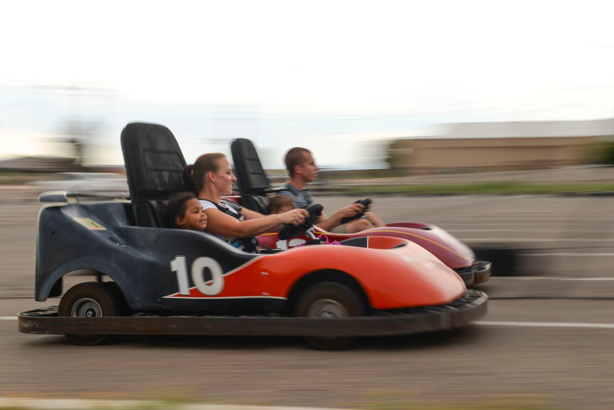 Members of Team Holloman cross the finish line in a go-cart during the Freedom Fest Independence Day celebration at Holloman Air Force Base, N.M., July 2, 2015. Freedom Fest took place in the Domenici Fitness and Sports Center parking lot and included carnival games, rides, and live music for Airmen and their families. (U.S. Air Force photo by Senior Airman Chase Cannon/Released)