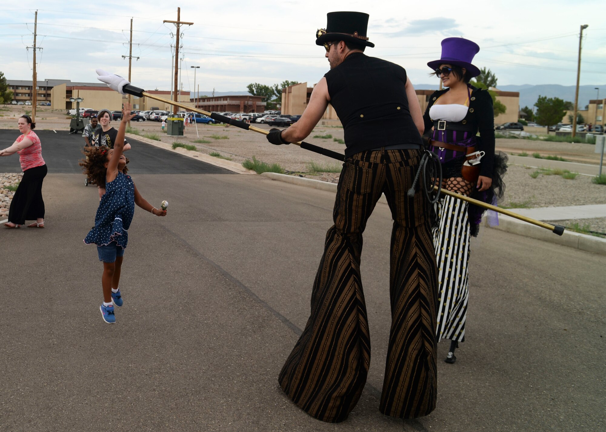 A child leaps for a high five during the Freedom Fest Independence Day celebration at Holloman Air Force Base, N.M., July 2, 2015. Families are encouraged to join the festivities during the celebration, which includes carnival games, live entertainment, food and a final firework show to end the night. (U.S. Air Force photo by Senior Airman Chase Cannon/Released)