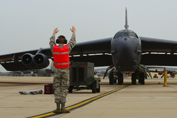 A B-52H Stratofortress is marshalled to a stop at Barksdale Air Force Base, La., after a 44-hour sortie July 2, 2015. Aircrew members and two B-52s from Barksdale AFB's 96th Bomb Squadron flew a round-trip mission to Australia where they integrated with Royal Australian Air Force ground forces in the region to conduct an exercise with inert conventional weapons and perform a low approach at RAAF Base Tindal, Australia. (U.S. Air Force photo/Senior Airman Benjamin Raughton)
