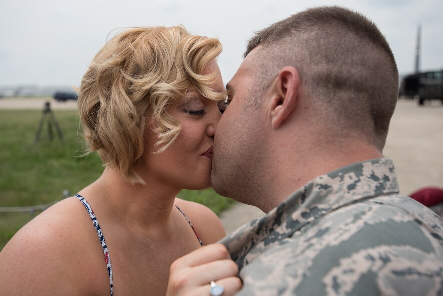 Vanna Jones kisses Tech. Sgt. Mike Johnson, a C-130 crew chief in the 123rd Airlift Wing, after he proposed to her on the flight line of the Kentucky Air National Guard Base in Louisville, Ky., July 4, 2015. Johnson had just returned from a deployment to the Persian Gulf region, where more than 100 members of the Kentucky Air Guard have been supporting Operation Freedom's Sentinel since February. (U.S. Air National Guard photo by Maj. Dale Greer)