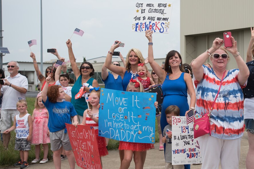 Hundreds of family and friends gather at the Kentucky Air National Guard Base in Louisville, Ky., July 4, 2015, to welcome home 39 Airmen as they return from a deployment in the Persian Gulf region. The Airmen, all members of the 123rd Airlift Wing, have been supporting Operation Freedom’s Sentinel since February. (U.S. Air National Guard photo by Maj. Dale Greer)