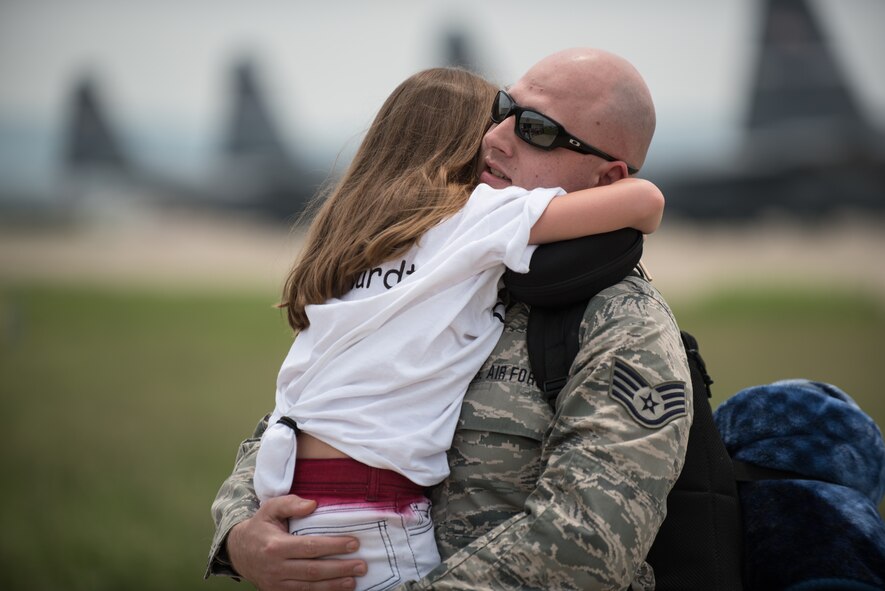 Staff Sgt. Brent Reichardt, an aircraft hydraulics specialist in the 123rd Airlift Wing, hugs his daughter during an emotional homecoming ceremony at the Kentucky Air National Guard Base in Louisville, Ky., July 4, 2015. Reichardt was among 39 Kentucky Air Guardsmen who were returning from a deployment to the Persian Gulf region, where they've been supporting Operation Freedom's Sentinel since February. (U.S. Air National Guard photo by Maj. Dale Greer)