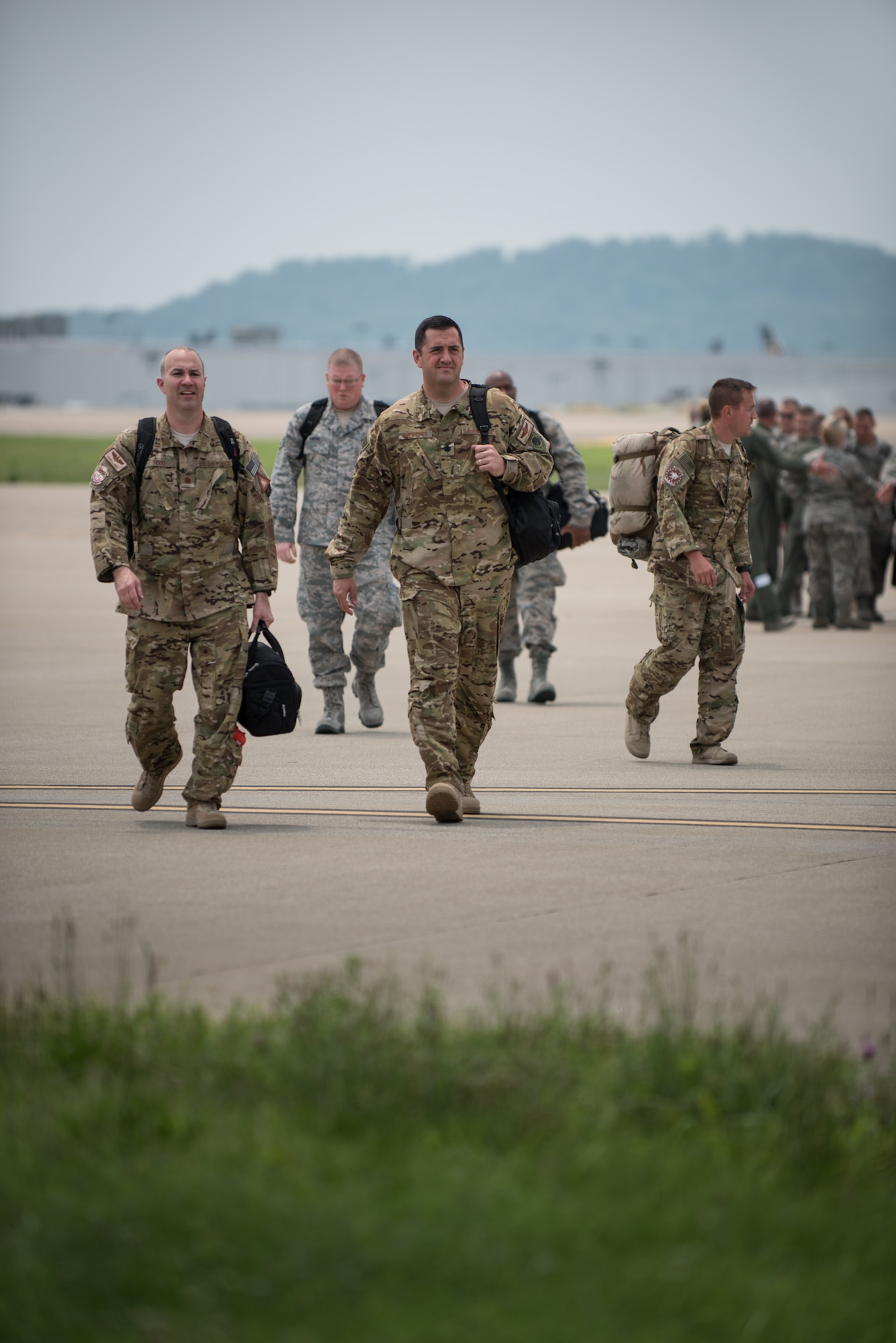 Airmen from the 123rd Airlift Wing walk from their C-130 Hercules aircraft toward a waiting crowd of hundreds of friends and family during a homecoming ceremony at the Kentucky Air National Guard Base in Louisville, Ky., July 4, 2015. The Airmen were returning from a deployment in the Persian Gulf region, where they've been supporting Operation Freedom's Sentinel since February. (U.S. Air National Guard photo by Maj. Dale Greer)