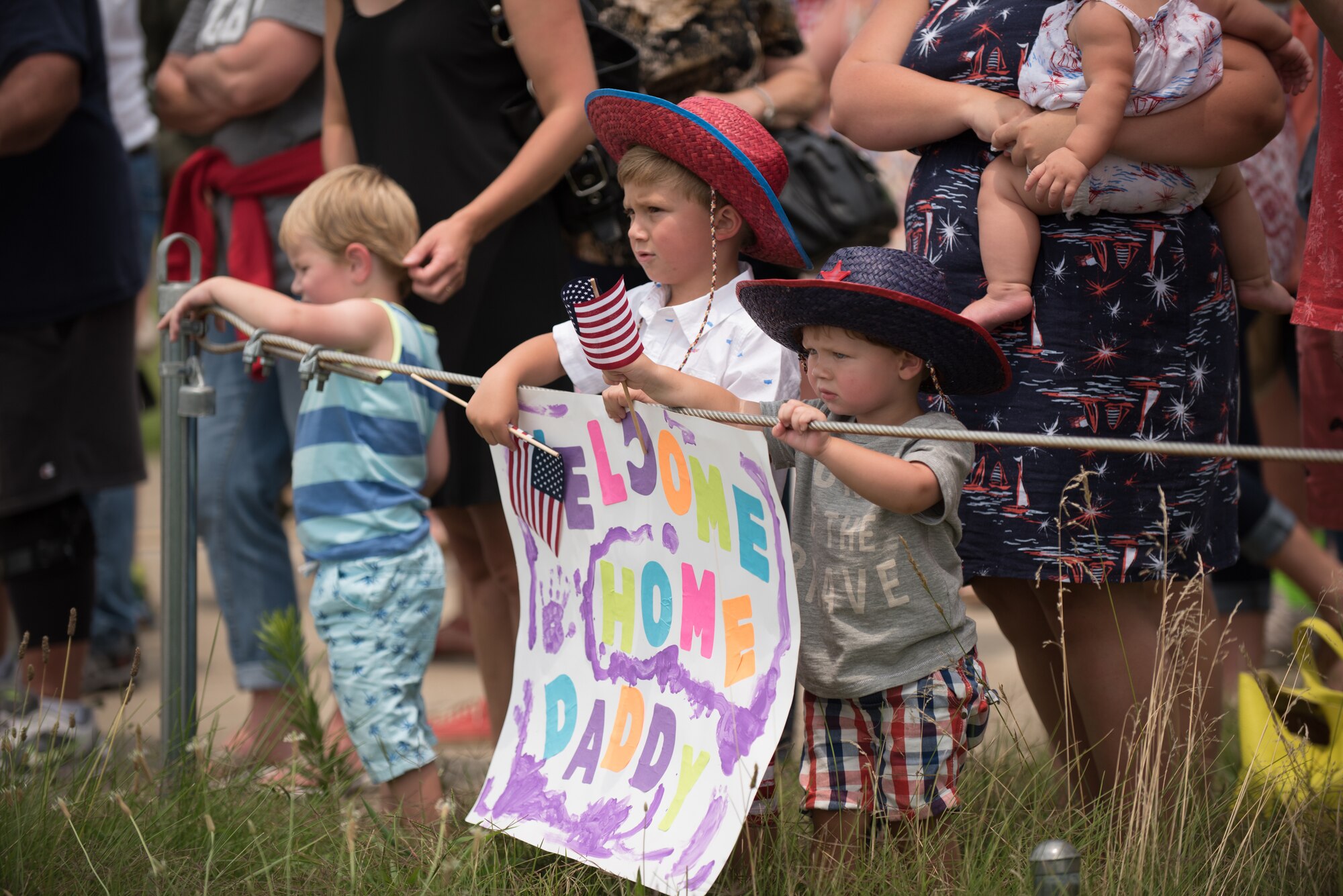Hundreds of family and friends gather at the Kentucky Air National Guard Base in Louisville, Ky., July 4, 2015, to welcome home 39 Airmen as they return from a deployment in the Persian Gulf region. The Airmen, all members of the 123rd Airlift Wing, have been supporting Operation Freedom’s Sentinel since February. (U.S. Air National Guard photo by Maj. Dale Greer)