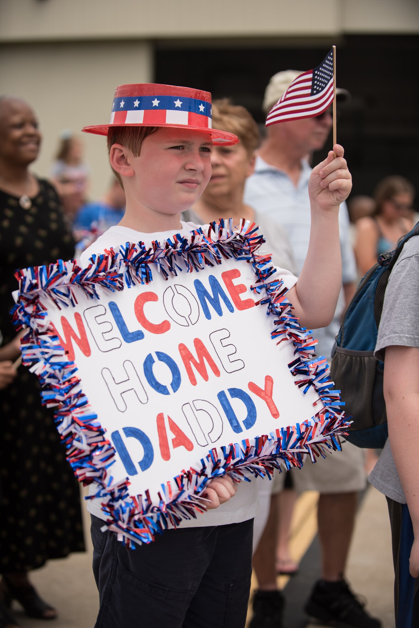 The son of a Kentucky Air National Guardsman waits for his father to step off a C-130 Hercules aircraft at the Kentucky Air National Guard Base in Louisville, Ky., July 4, 2105. The father was one of 39 Kentucky Airmen who returned to the United States following a deployment in the Persian Gulf region, where they've been supporting Operation Freedom's Sentinel since February. (U.S. Air National Guard photo by Maj. Dale Greer)