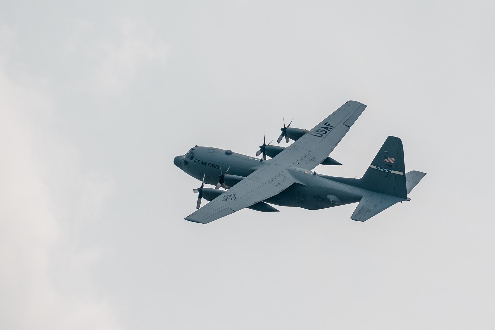 A C-130 Hercules aircraft banks over the Kentucky Air National Guard Base in Louisville, Ky., July 4, 2015, carrying 39 Airmen returning from a deployment in the Persian Gulf region. The Kentucky Air Guard's 123rd Airlift Wing has been supporting Operation Freedom's Sentinel in the U.S. Central Command Area of Responsibility since February. (U.S. Air National Guard photo by Maj. Dale Greer)