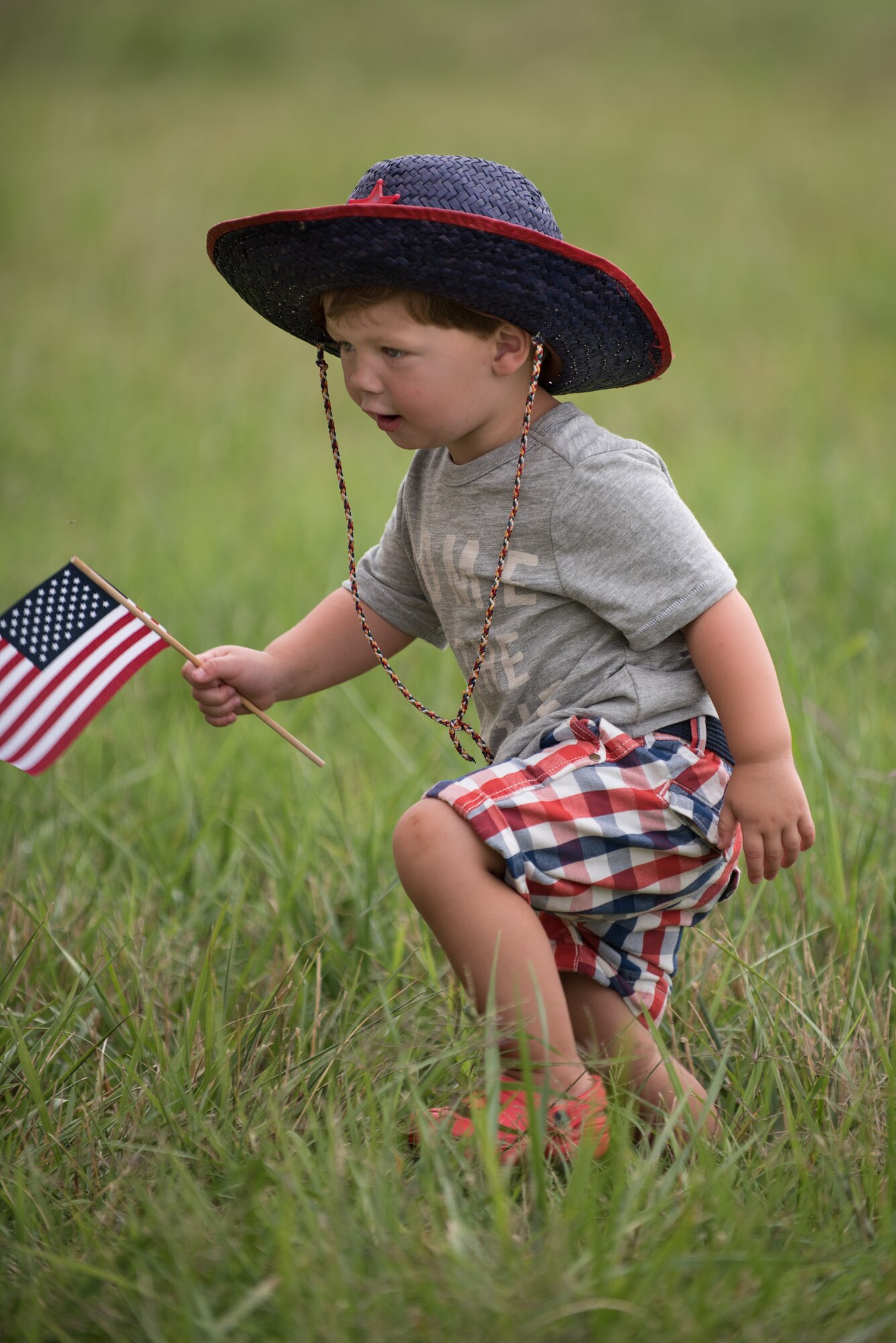Two-year-old Max Gordon plays in the grass at the Kentucky Air National Guard Base in Louisville, Ky., July 4, 2015, as he waits for his uncle, Master Sgt. Aaron Schalck, to return from a deployment in the Persian Gulf region. Airmen from the Kentucky Air Guard's 123rd Airlift Wing have been supporting Operation Freedom's Sentinel in the U.S. Central Command Area of Responsibility since February. (U.S. Air National Guard photo by Maj. Dale Greer)
