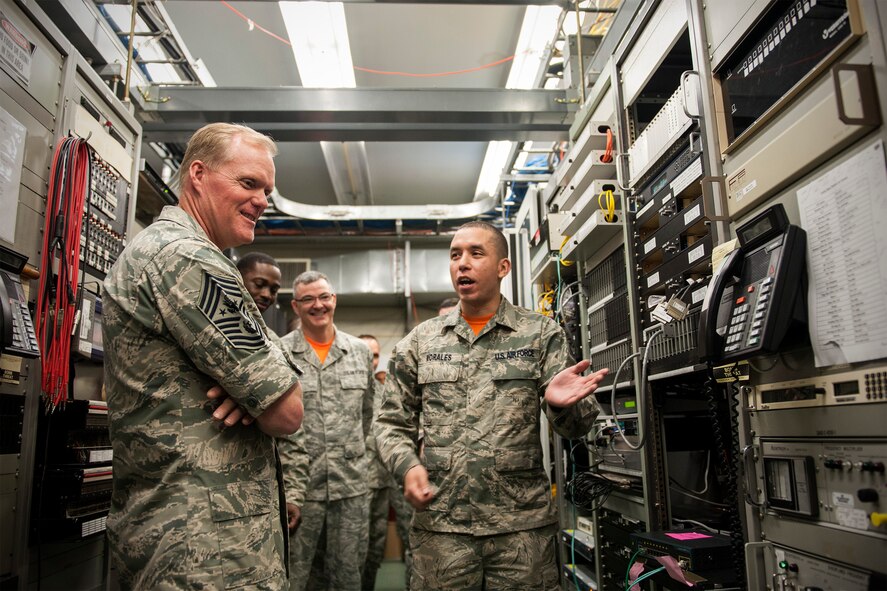 Senior Airman Luis Morales, 8th Communications Squadron technician, explains the Wolf Pack’s main circuit structure to Chief Master Sgt. of the Air Force James A. Cody at Kunsan Air Base, Republic of Korea, July 3, 2015. Cody met with Airmen from the 8th Fighter Wing during his first visit to Kunsan July 2 and 3 to see first-hand how the Wolf Pack trains to defend the base, accept follow-on forces and take the fight north. (U.S. Air Force photo by Senior Airman Katrina Heikkinen/Released)