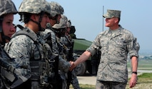 Chief Master Sgt. of the Air Force James A. Cody meets defenders from the 8th Security Forces Squadron during an immersion tour at Kunsan Air Base, Republic of Korea, July 2, 2015. Cody engaged with Wolf Pack Airmen to answer questions and give insight on key Air Force topics and changes. (U.S. Air Force photo by Staff Sgt. Nick Wilson/Released)