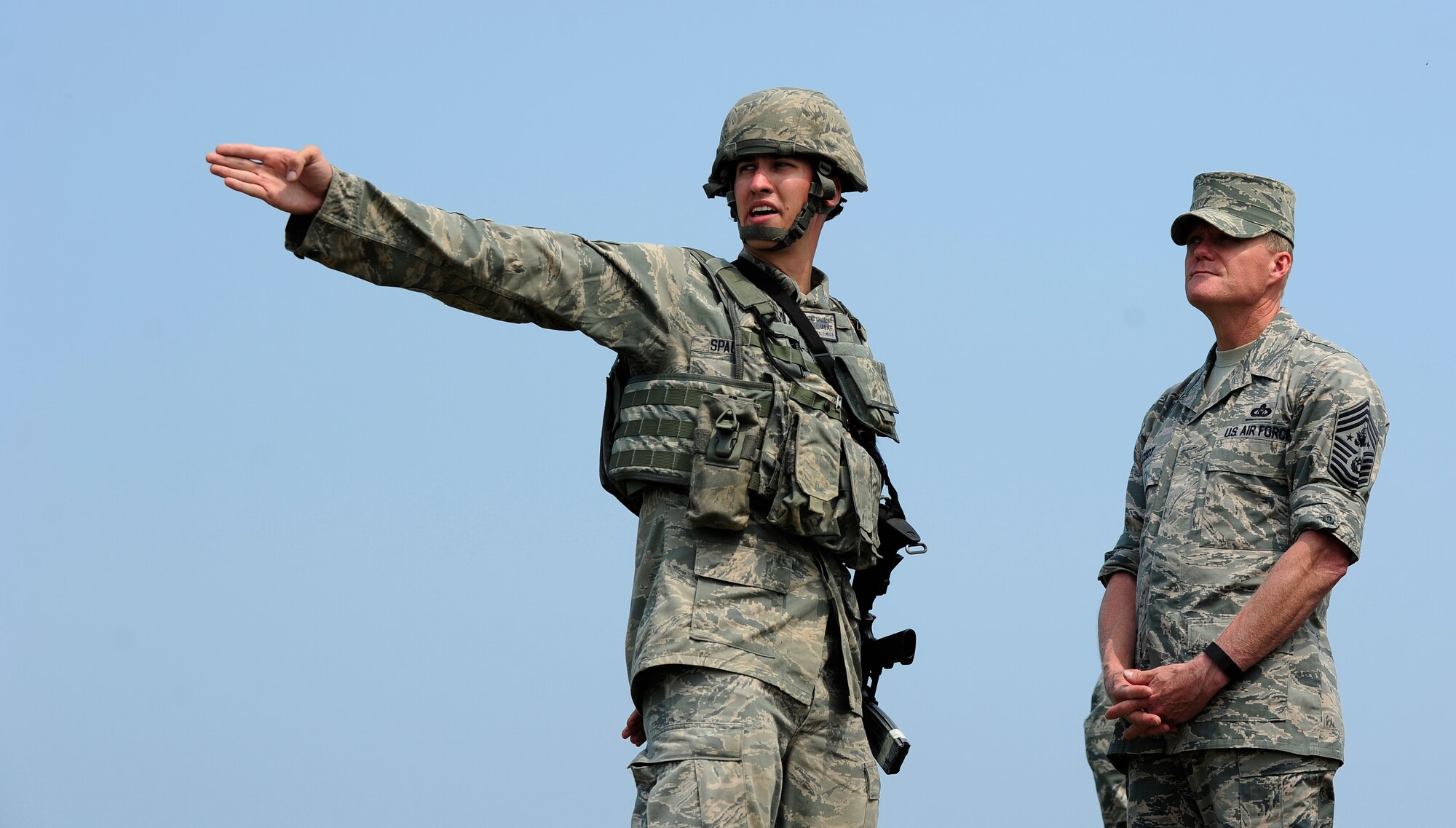 Senior Airman Edward Spalione, 8th Security Forces Squadron response force leader, gives an immersion brief to Chief Master Sgt. of the Air Force James A. Cody at Kunsan Air Base, Republic of Korea, July 2, 2015. Cody engaged with Wolf Pack Airmen to answer questions and give insight on key Air Force topics and changes. (U.S. Air Force photo by Staff Sgt. Nick Wilson/Released)
