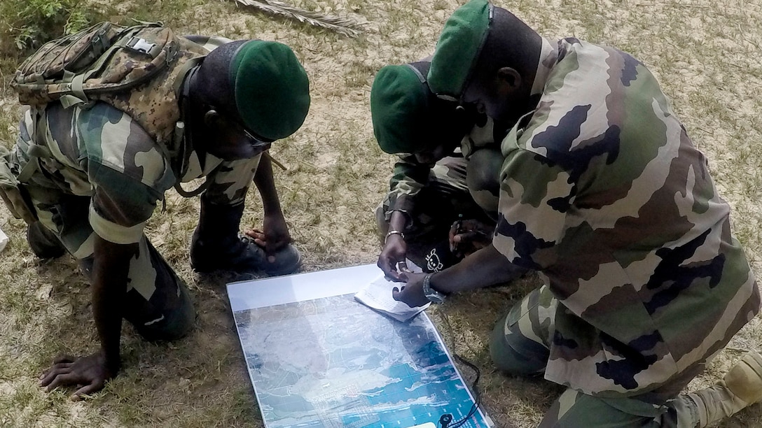 Senegalese Fusilier de Marine Commandos during plot a route during land navigation training, near St. Louis, Senegal, in early June 2015. A team of approximately 10 U.S. Marines, Sailors and Coast Guardsmen and Senegalese Compagnie Fusilier de Marine Commandos are working together as part of a Maritime Security Force Assistance training program to improve the light infantry and small boat operations skills.