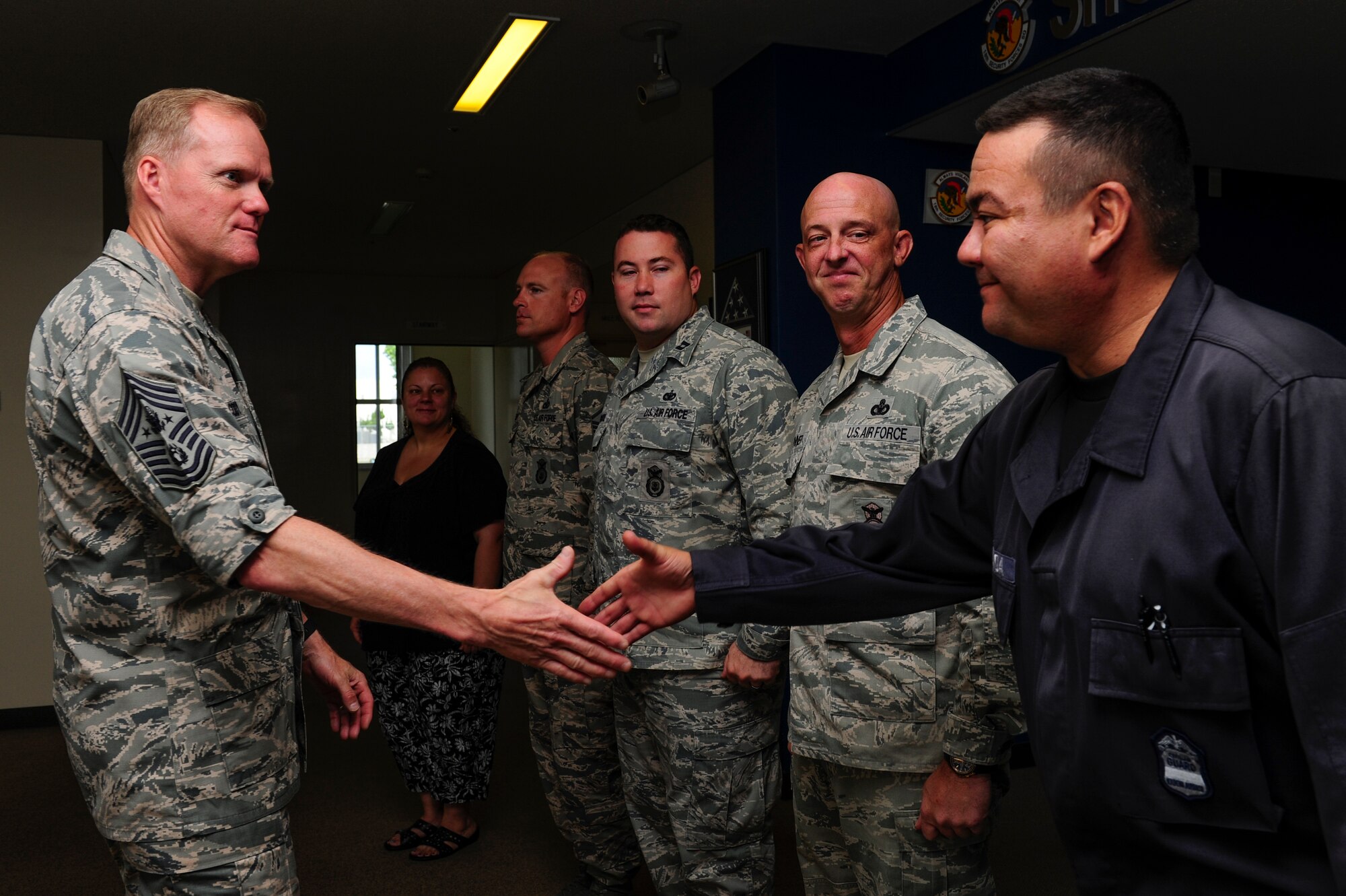 Chief Master Sgt. of the Air Force James Cody shakes hands with Kenichi Shimada, 18th Security Forces Squadron Military Local Contractor program manager July 6, 2015, at Kadena Air Base, Japan. Cody met with Airmen and MLCs throughout Kadena, as part of his ongoing initiative to engage with Airmen stationed around the globe. (U.S. Air Force photo by Airman 1st Class John Linzmeier) 