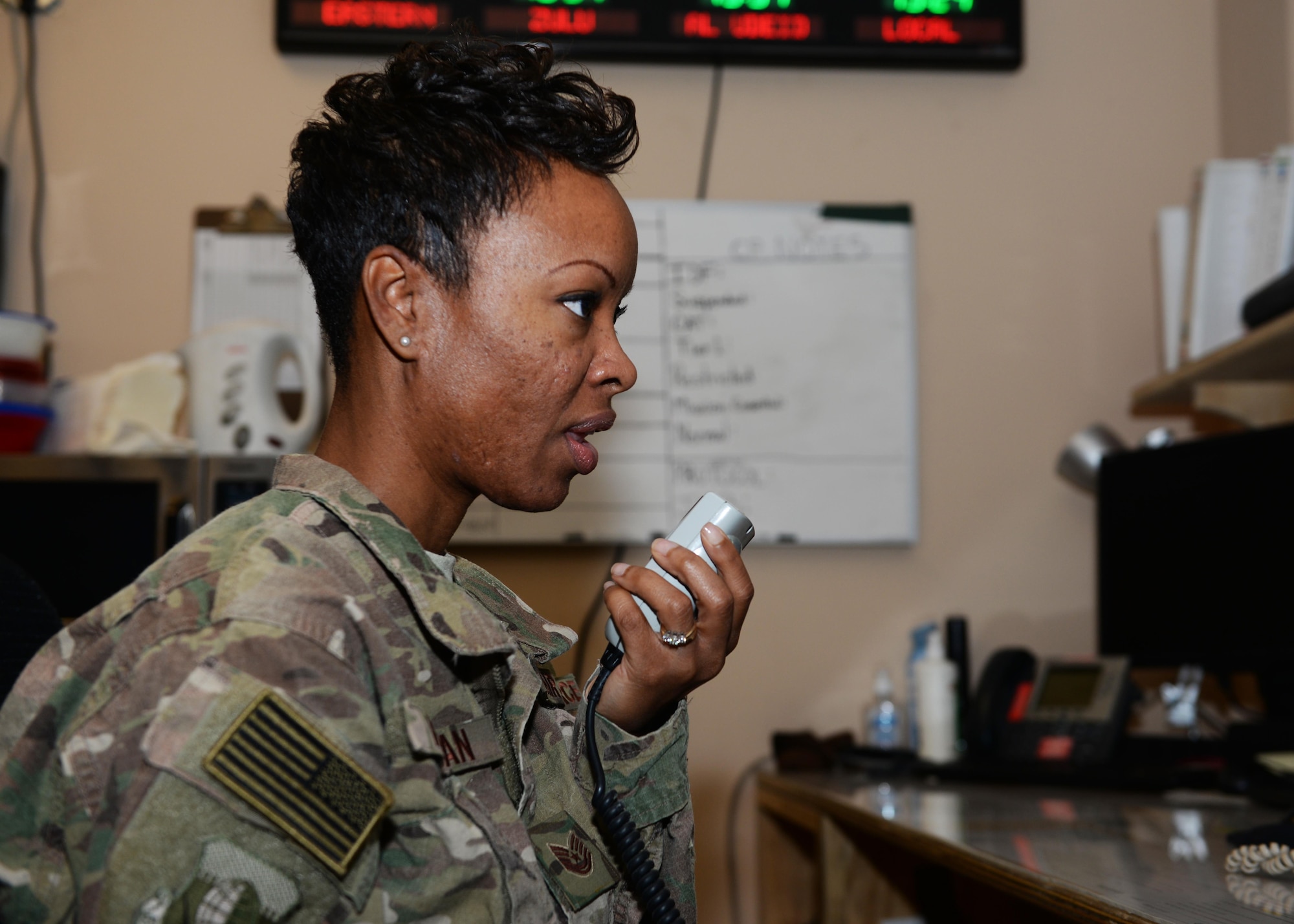 U.S. Air Force Tech. Sgt. Samantha Morgan, 455th Air Expeditionary Wing Command Post non-commissioned officer in charge of operations, relays a message to an inbound flight crew July 6, 2015, at Bagram Airfield, Afghanistan. Morgan and her team are responsible for initiating wing recalls, relaying weather and inbound attack notifications to the base as well as work with aircrews and other various agencies in keeping the base abreast on important information. (U.S. Air Force photo by Senior Airman Cierra Presentado/Released)