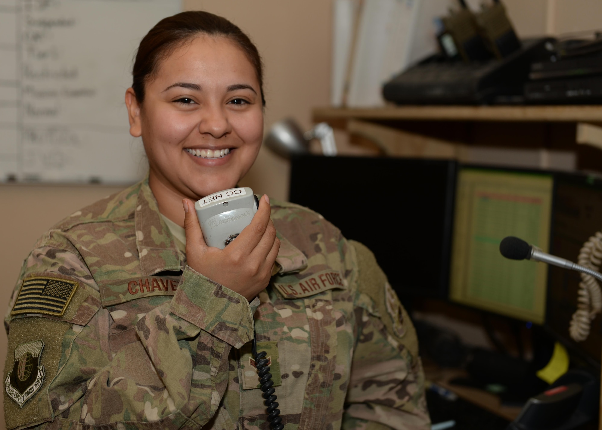 U.S. Air Force Airman 1st Class Judy Chavez-Colorado, 455th Air Expeditionary Wing Command Post emergency actions controller, poses for a photo July 6, 2015, at Bagram Airfield, Afghanistan. Chavez-Colorado and her team are responsible for initiating wing recalls, relaying weather and inbound attack notifications to the base as well as work with aircrews and other various agencies in keeping the base abreast on important information. (U.S. Air Force photo by Senior Airman Cierra Presentado/Released)