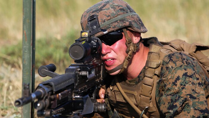 Lance Cpl. Levi Hall with Golf Company, Black Sea Rotational Force, sights in on the M240B medium machine gun at the support-by-fire position during the dry-run of the U.S. and Romanian platoon attacks at Babadag Training Area, July 2.  This week-long engagement is part of a continuous military skills series between BSRF and the Romanian 307th Naval Infantry. 