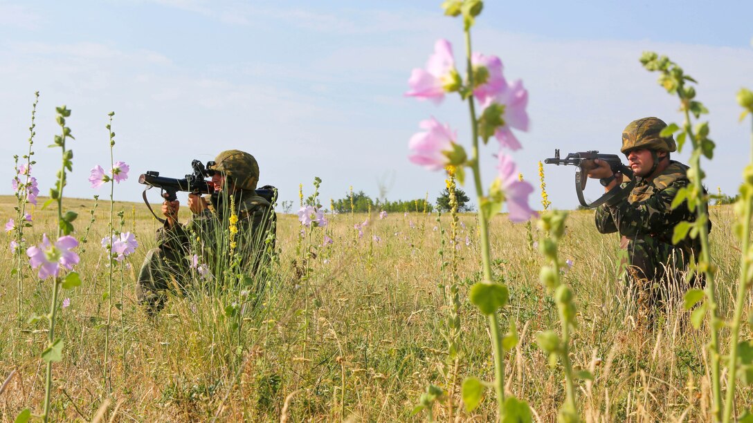 A Romanian marine with the 307th Naval Infantry Battalion sights in on the rocket propelled grenade launcher while another provides security during the dry-run of the Romanian platoon-attack at Babadag Training Area, July 2. U.S. and Romanian troops conducted live-fire platoon attacks at BTA as the culmination of monthly military-to-military engagements between BSRF and the Romanian 307th Naval Infantry. 