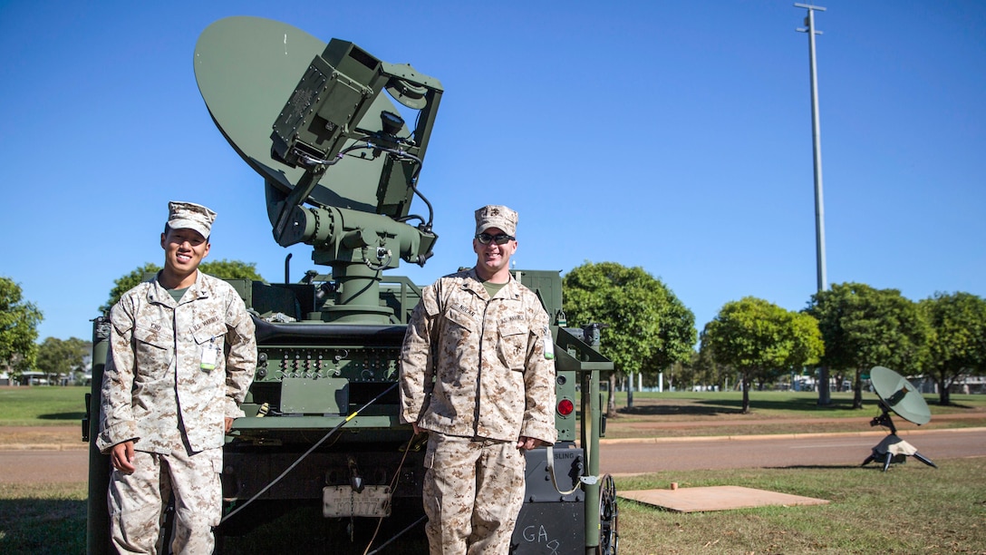 U.S. Marines, Cpl. Shea P. Nolan and Lance Cpl. Edward Y. Cho, stand in front of a Secure, Mobile, Anti-Jam, Reliable, Tactical-Terminal during exercise Talisman Sabre 2015 at Robertson Barracks, Australia, July 6. The exercise is designed to improve U.S.-Australian combat training, readiness and interoperability. Nolan, from Wallington, New Jersey, is a tropospheric scatter radio multi-channel equipment operator. Cho, from Dix Hills, New York, is a satellite communications operator and maintainer. They are with 7th Communication Battalion, III Marine Expeditionary Force Headquarters Group, III MEF, currently attached to 3rd Marine Expeditionary Brigade. 