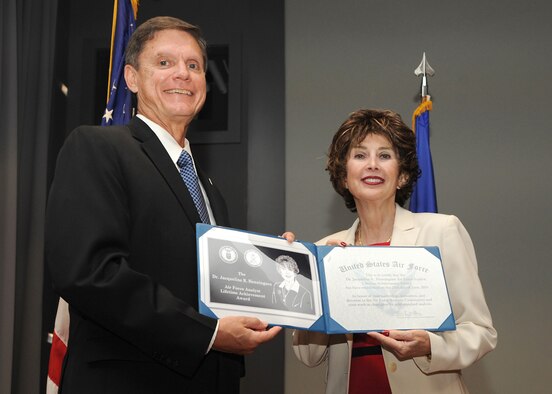 Kevin E. Williams, Director, Air Force Studies, Analyses and Assessments, presents Dr. Jacqueline R. Henningsen with a certificate during the 2014 Analysis, Assessments, and Lessons Learned Awards ceremony at the Mark Center, Arlington, Va., June 25, 2015. (U.S. Air force photo/Staff Sgt. Whitney Stanfield)