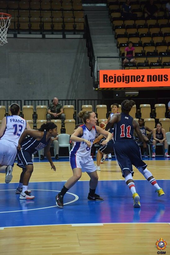 Army Sgt Kimberly Smith (#11) drives through the paint during the bronze medal game against France.  USA defeats France 78-41 during the 1st Conseil International du Sport Militaire (CISM) World Women's Basketball Championship in Angers, France June 28 to July 5.  