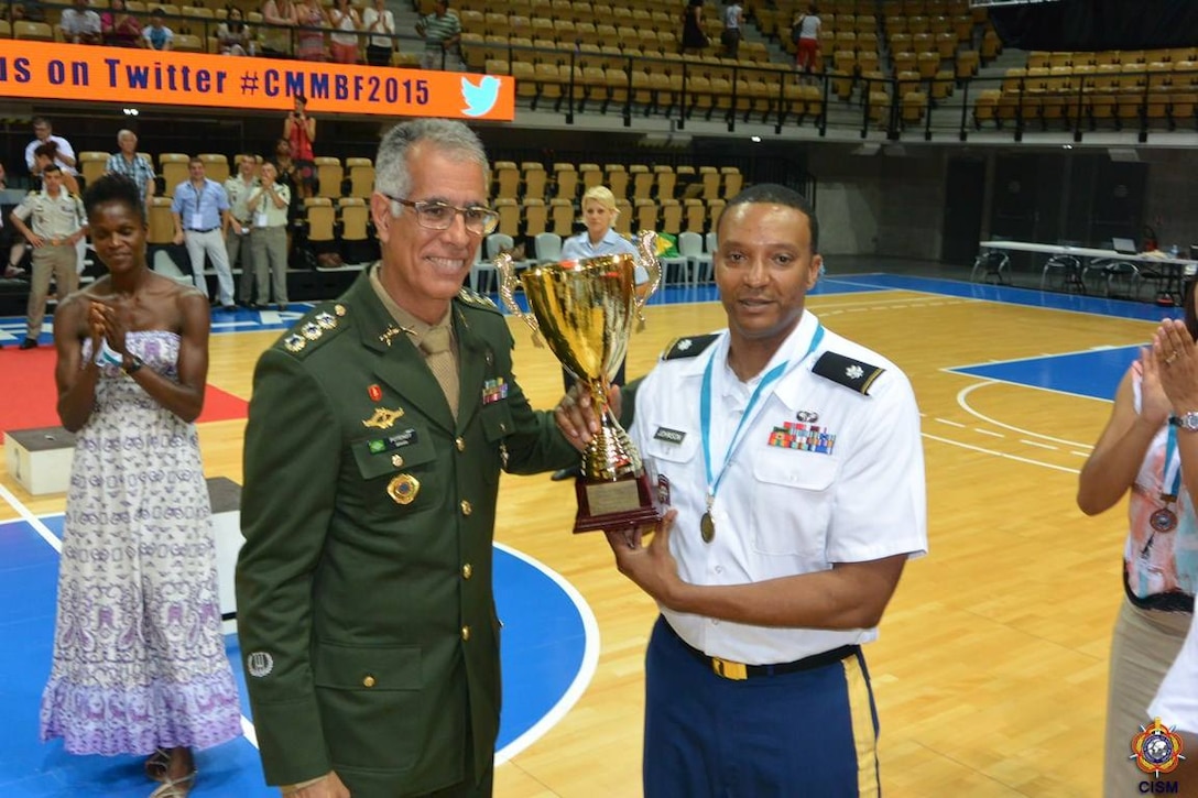CISM Basketball President Col. Marcio Potengy (Brazil) presents the third place trophy to U.S. Armed Forces Coach Army Lt. Col. William Johnson of Fort Sill, Okla.  USA defeats France 78-41 during the 1st Conseil International du Sport Militaire (CISM) World Women's Basketball Championship in Angers, France June 28 to July 5.  