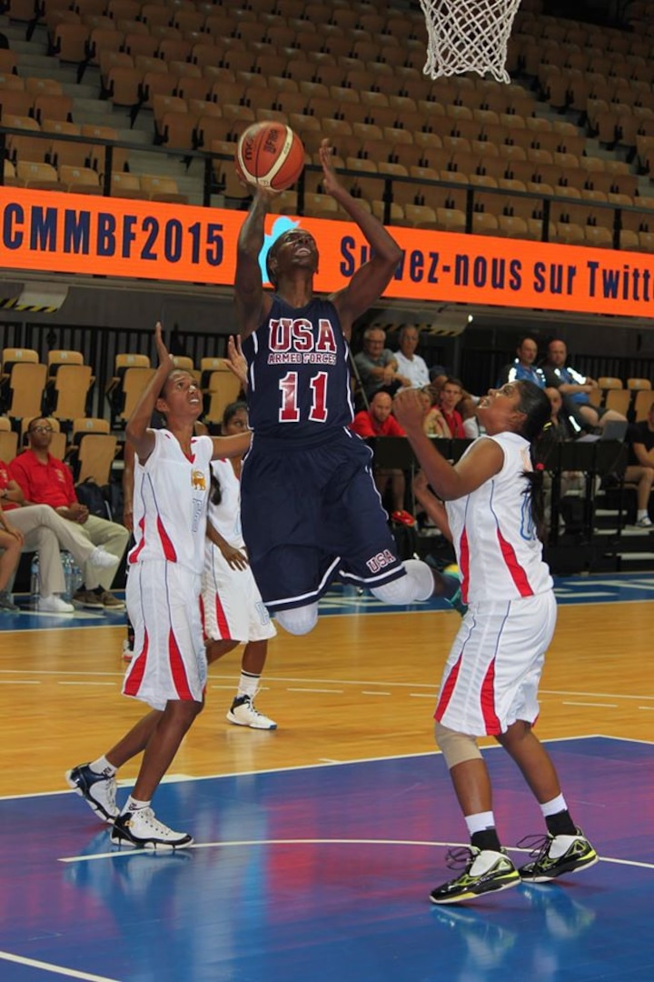 Army Sgt. Kimberly Smith of Fort Riley, Kan. lays up for the score against Sri Lanka. USA defeats Sri Lanka 137-37 during the 1st Conseil International du Sport Militaire (CISM) World Women's Basketball Championship in Angers, France June 28 to July 5.  