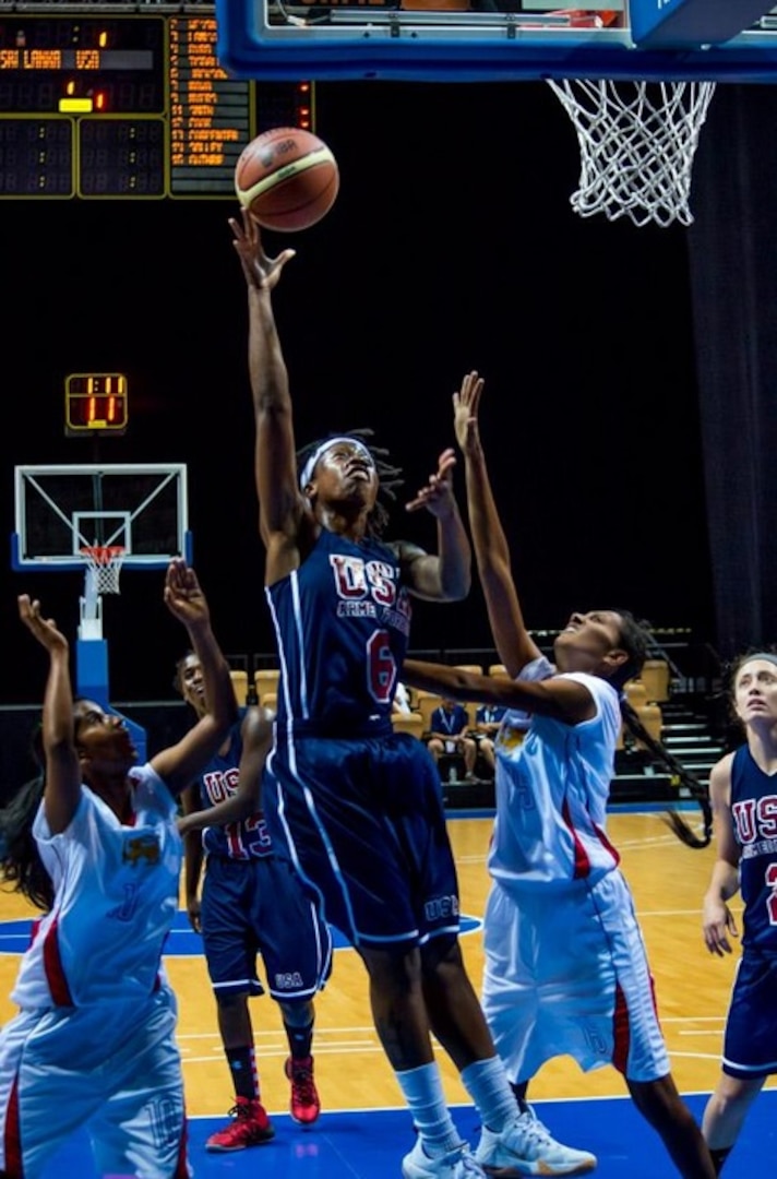 Navy Seaman Courtney Jackson scores against Sri Lanka. USA defeats Sri Lanka 137-37 during the 1st Conseil International du Sport Militaire (CISM) World Women's Basketball Championship in Angers, France June 28 to July 5.  