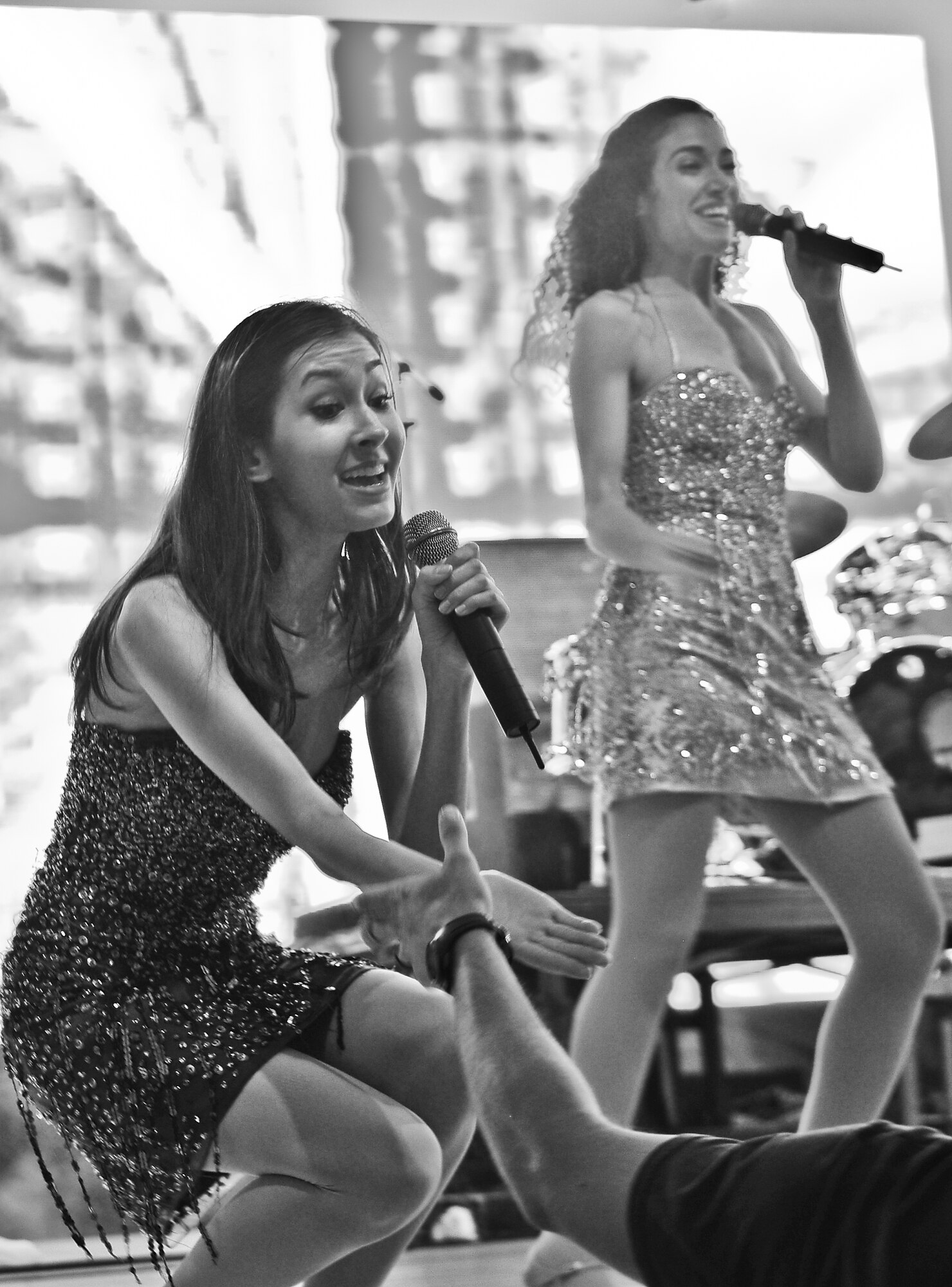 Bryna O’Neill, USO Show Troupe singer, interacts with a member of the audience during the Liberty Fest concert July 4, 2015 at Osan Air Base, Republic of Korea. She and three other members of the USO Show Troupe sang top Billboard hits as part of the entertainment in celebration of Independence Day. (U.S. Air Force photo/Tech. Sgt. Travis Edwards)