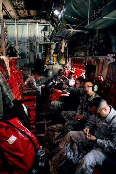 Yokota Airmen sit aboard a C-130 Hercules at Yokota Air Base, Japan, May 5, 2015. Members onboard left to help aid in the disaster relief effort in the wake of Nepal's earthquake. (U.S. Air Force photo by Airman 1st Class Delano Scott/Released)