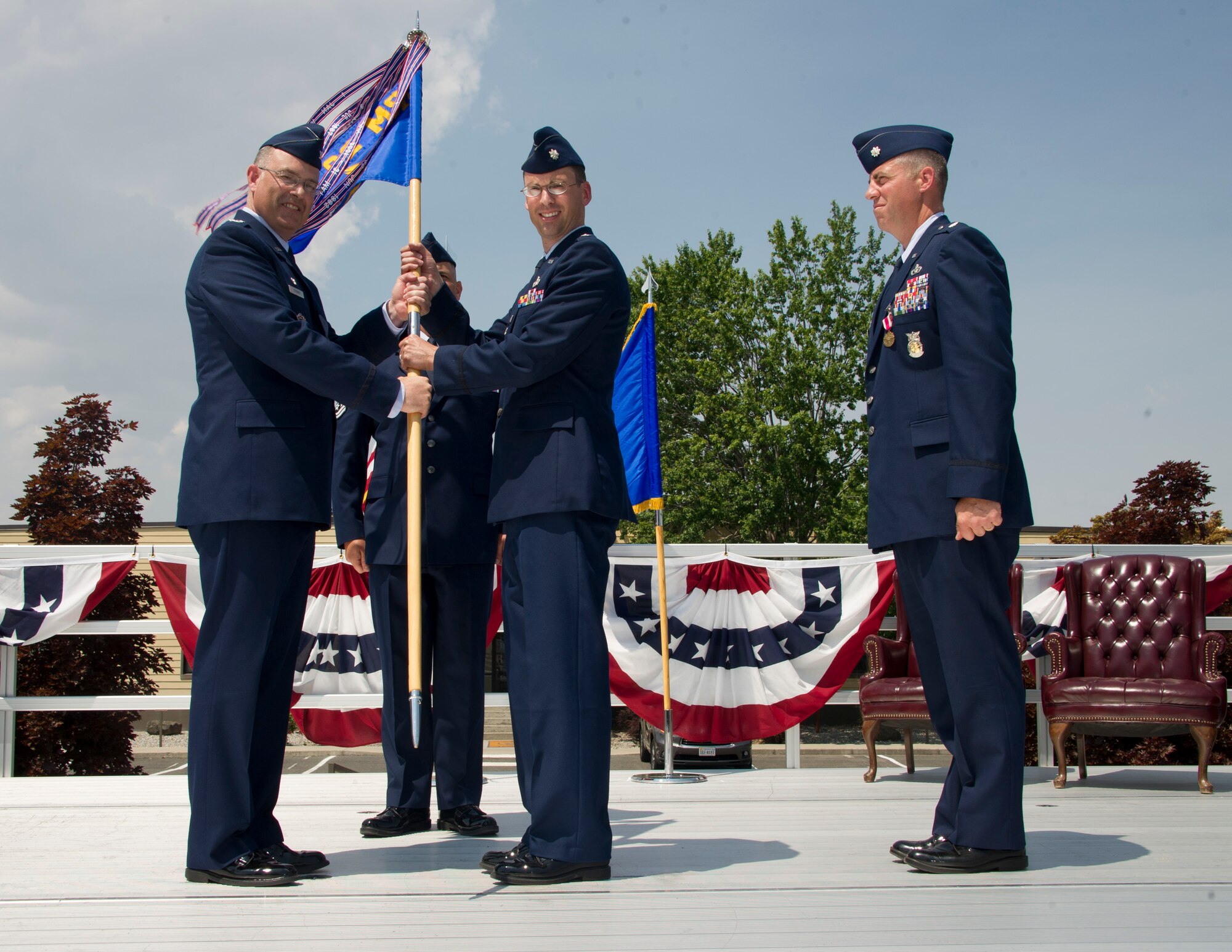 Col. David Stookey, 92nd Mission Support Group commander, presents the 92nd Civil Engineer Squadron guidon to Lt. Col. Ross Gleason during the 92nd CES change of command, July 6, 2015, at Fairchild Air Force Base, Wash. Previously, Gleason was the Deputy Chief, Readiness Division, Headquarters United States Air Forces Europe, at Ramstein Air Base, Germany. (U.S. Air Force photo/Airman 1st Class Nicolo J. Daniello)