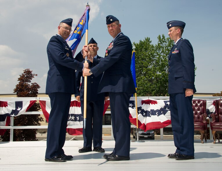 Col. David Stookey, 92nd Mission Support Group commander, receives the 92nd Civil Engineer Squadron guidon from Lt. Col. Jason Campbell during the 92nd CES change of command ceremony, July 6, 2015, at Fairchild Air Force Base, Wash. Campbell relinquished his position as the 92nd CES commander in the change of command ceremony. (U.S. Air Force photo/Airman 1st Class Nicolo J. Daniello)