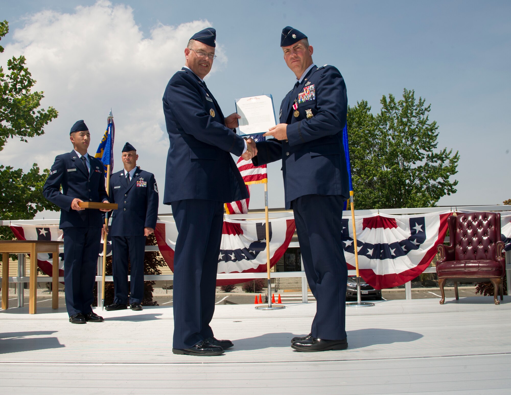 Col. David Stookey, 92nd Mission Support Group commander, presents the Meritorious Service Medal certificate to Lt. Col. Jason Campbell, former 92nd Civil Engineer Squadron commander, during the 92nd CES change of command, July 6, 2015, at Fairchild Air Force Base, Wash. The Meritorious Service Medal is an award given for outstanding meritorious achievement. (U.S. Air Force photo/Airman 1st Class Nicolo J. Daniello)