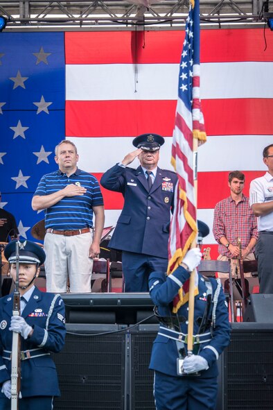 Col. Brian McDaniel, 92nd Air Refueling Wing commander, salutes as the Fairchild Honor Guard presents the colors during the singing of the national anthem kicking off Fourth of July celebrations at Riverfront Park July 4, 2015, in Spokane, Wash. The honor guard provides military honors at various events across their area of responsibility in Washington, Idaho and Oregon, for active duty, retirees, Veterans and the American Flag. (U.S. Air Force photo/Staff Sgt. Benjamin W. Stratton)