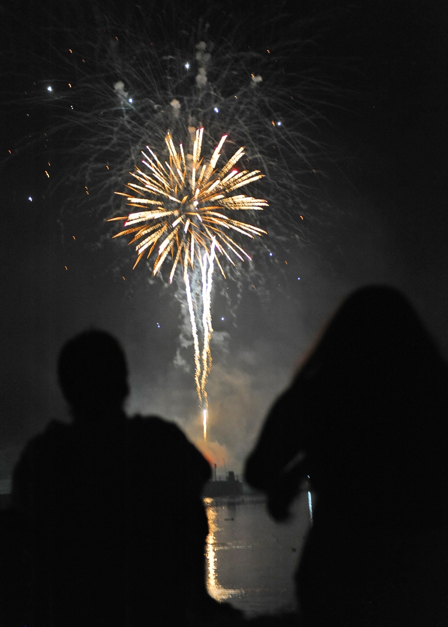 Attendees watch in awe of the fireworks display July 4 at Fireworks on the Water event. The event included food vendors, live music and an 18-minute fireworks display. (U.S. Air Force photo/Airman 1st Class John Day)