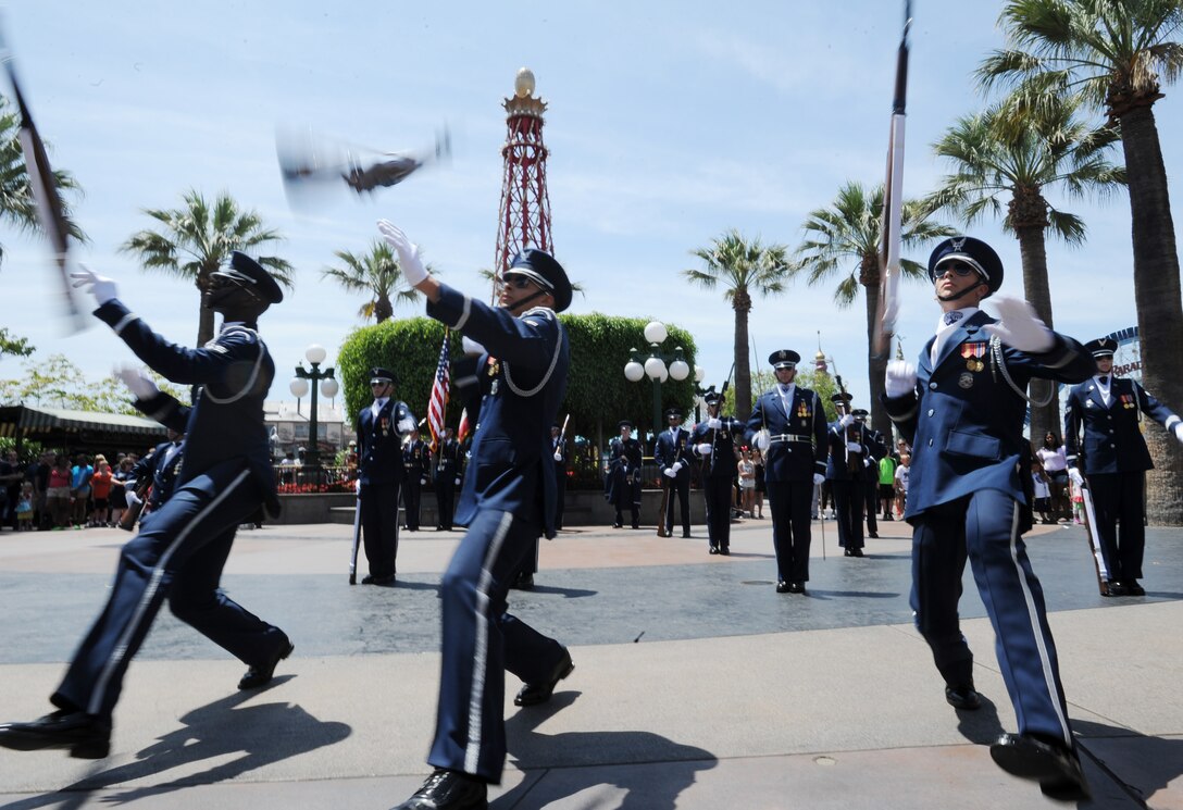 The United States Air Force Honor Guard performs at Disneyland in Anaheim, Calif., July 2, 2015. During the Fourth of July weekend each year, Disneyland invites military units to the park for special performances, a tradition started by Walt Disney on opening day. (U.S. Air Force photo/Staff Sgt. Nichelle Anderson)