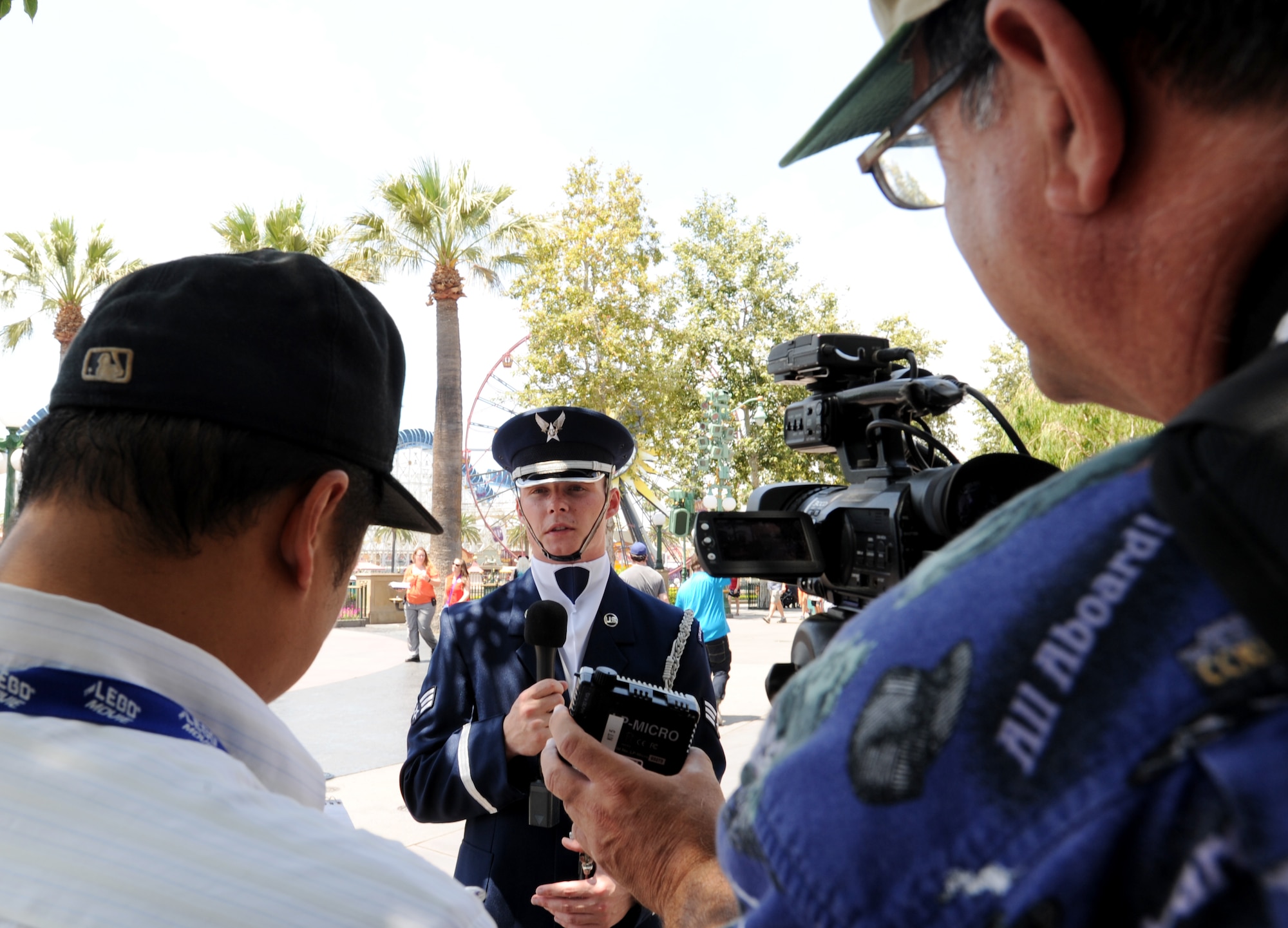 Senior Airman Christopher Horton, Unites States Air Force Honor Guard drill team member, is interviewed by local reporters after a performance at Disney's California Adventure Park in Anaheim, Calif., July 2, 2015. Horton is an Orange County native and has been in the honor guard for two years. (U.S. Air Force photo/ Staff Sgt. Nichelle Anderson)