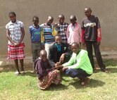 Staff Sgt. Dominic Kosgei (center with bow tie) stands with a group of orphaned children.  Kosgei,  NCO in charge of traffic management for the 377th Logistics Readiness Squadron, visits his homeland of Kenya every year to help an orphanage. He was the Air Force recipient for the 2015 American Legion Spirit of Service Award. (Courtesy photo)