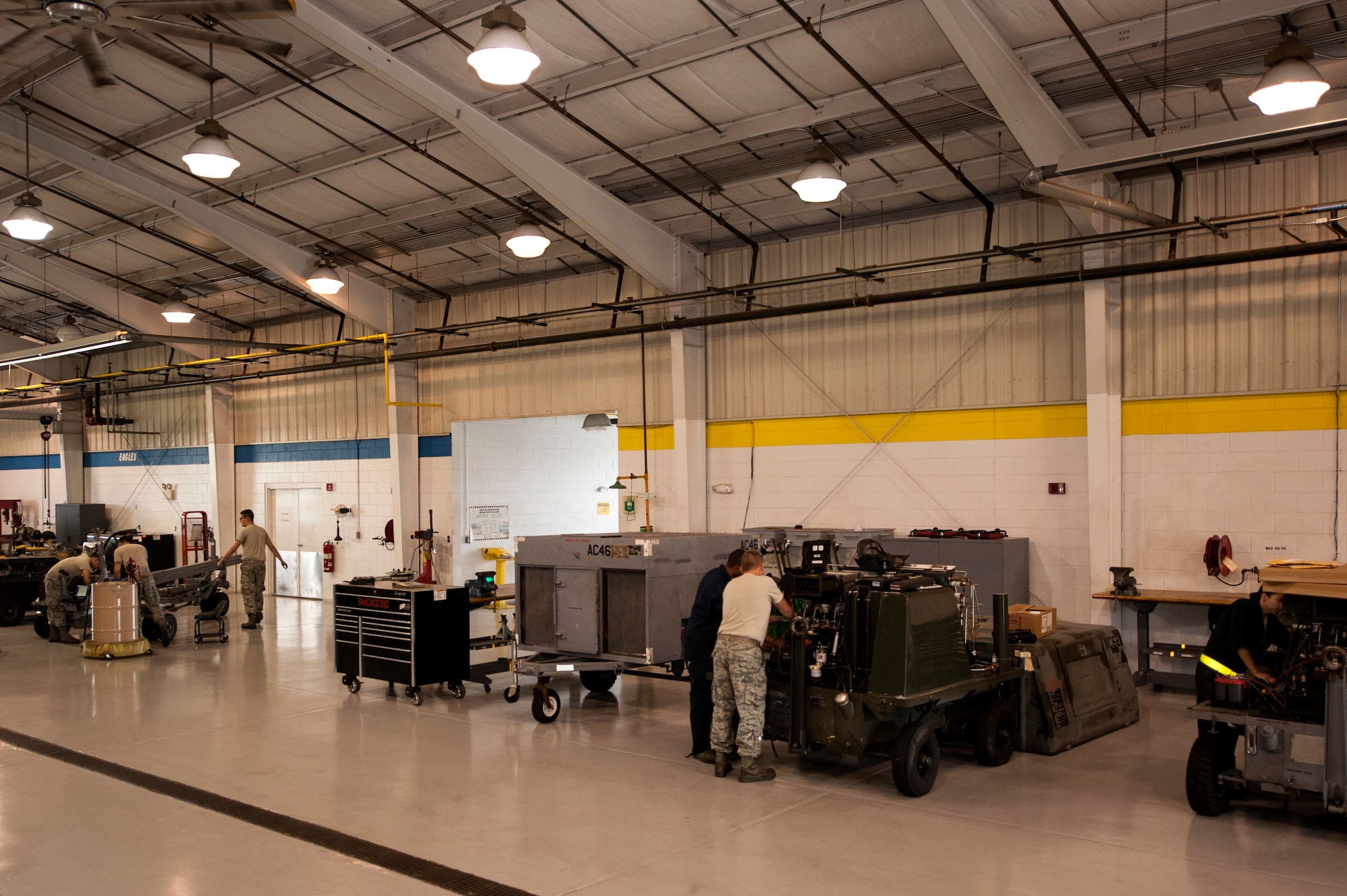 Airmen from the 4th Equipment Maintenance Squadron aerospace ground equipment flight work on various equipment brought in from the flightline, June 25, 2015, at Seymour Johnson Air Force Base, North Carolina. With more than 600 pieces of equipment in their keep, AGE personnel are responsible for maintenance and inspections to keep everything flightline ready to support flying operations. (U.S. Air Force photo/Airman Shawna L. Keyes)