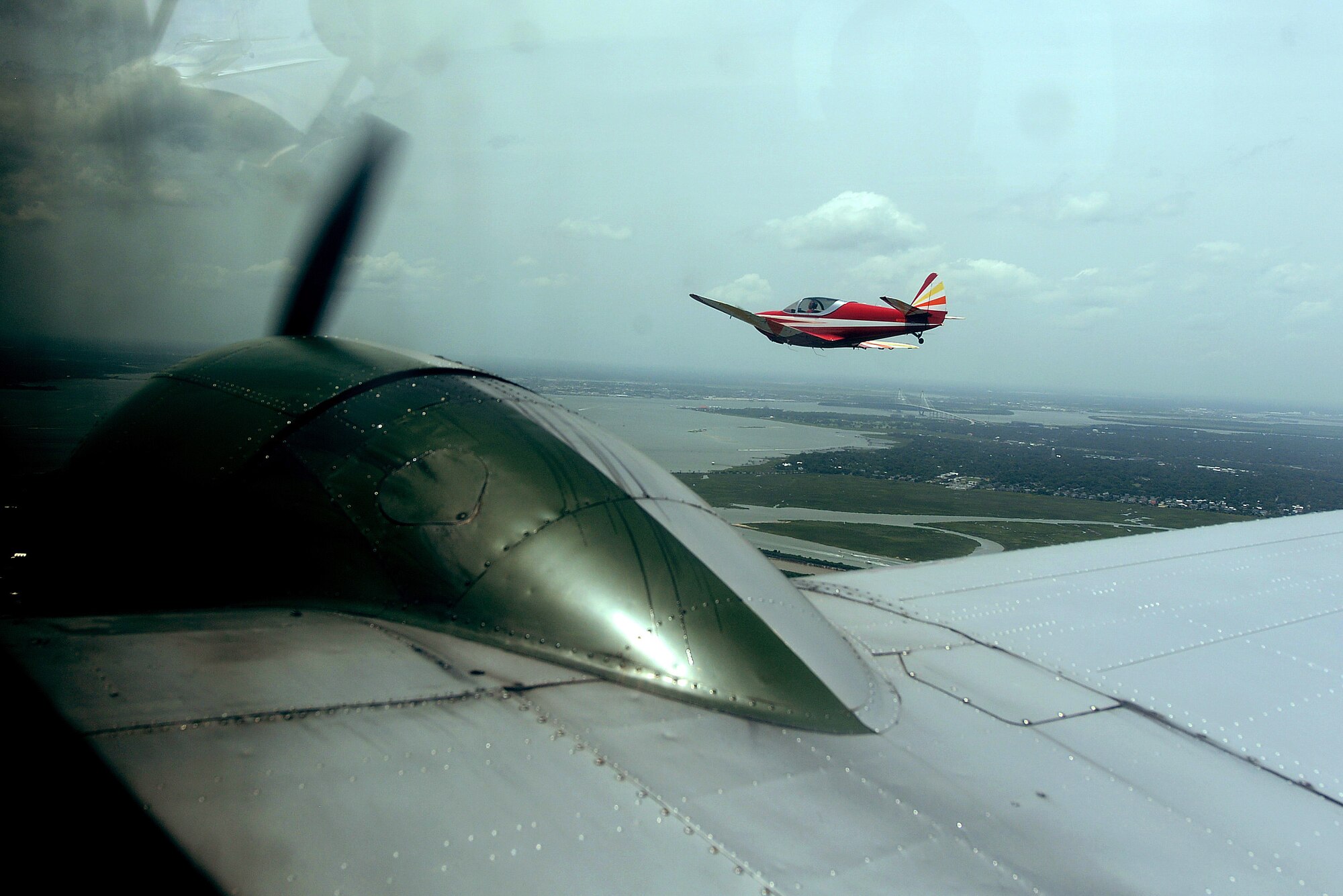 Vintage WWII aircraft fly in formation during a Salute from the Shore air parade down the coast of South Carolina, July 4, 2015. Salute from the Shore, Inc., is a non-profit organization that coordinates a fly-by of military and vintage military aircraft along the shore of S.C. starting at Cherry Grove, just north of Myrtle Beach, and ending at Hilton Head Island in the southern part of S.C. Their mission is to honor the U.S. Armed Forces, past and present, through a free and public pass in review of the aircraft. (U.S. Air Force photo by Senior Airman Diana M. Cossaboom/Released)