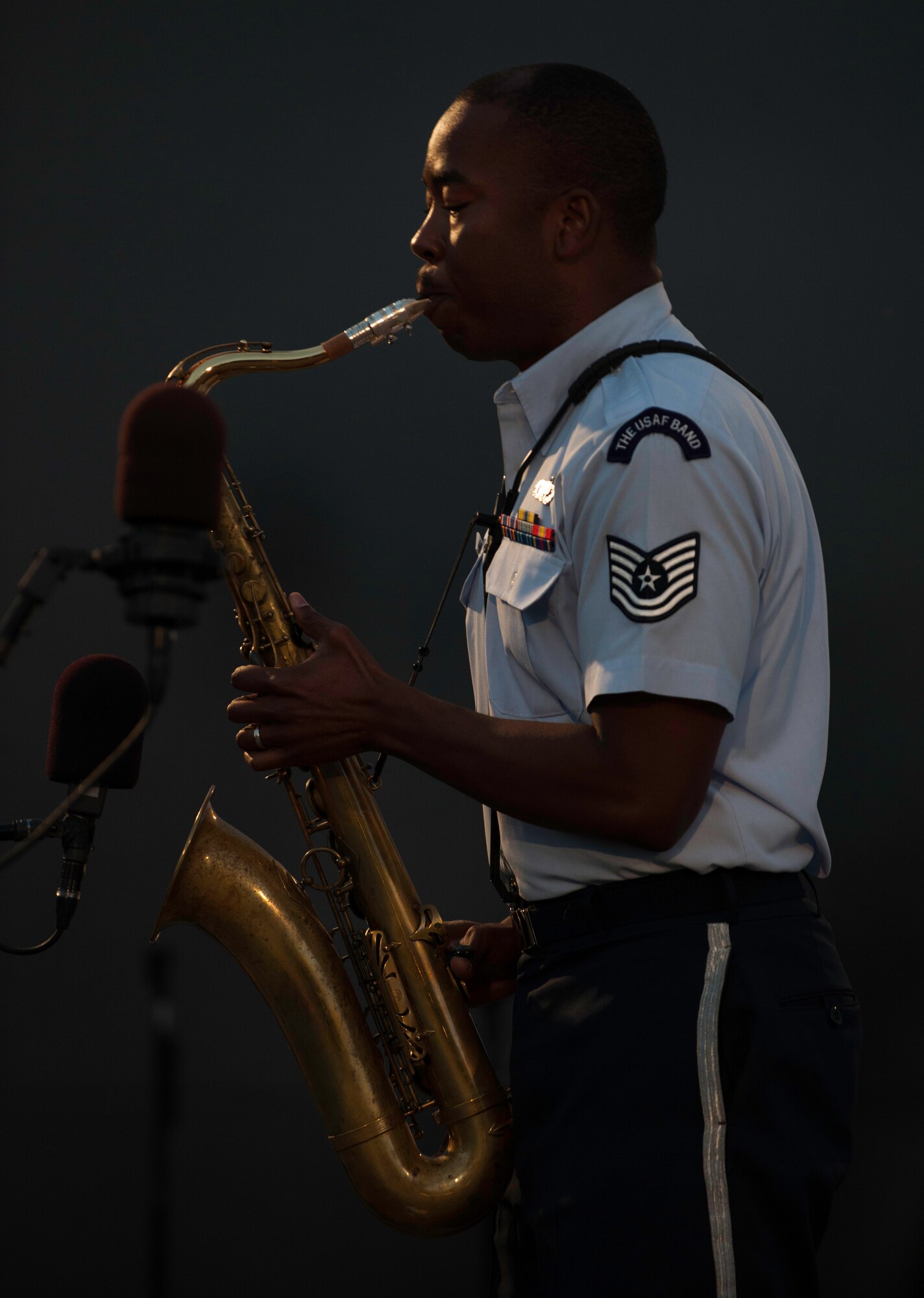 Tech. Sgt. Grant Langford, U.S. Air Force Band’s Airmen of Note tenor saxophonist, performs during a concert at the U.S. Air Force Memorial in Arlington, Va., before the fireworks celebration in Washington, D.C., July 4, 2015.  Throughout the concert, band members came to center of stage show off individual instrumental skill. (U.S. Air Force photo/Airman 1st Class Philip Bryant)