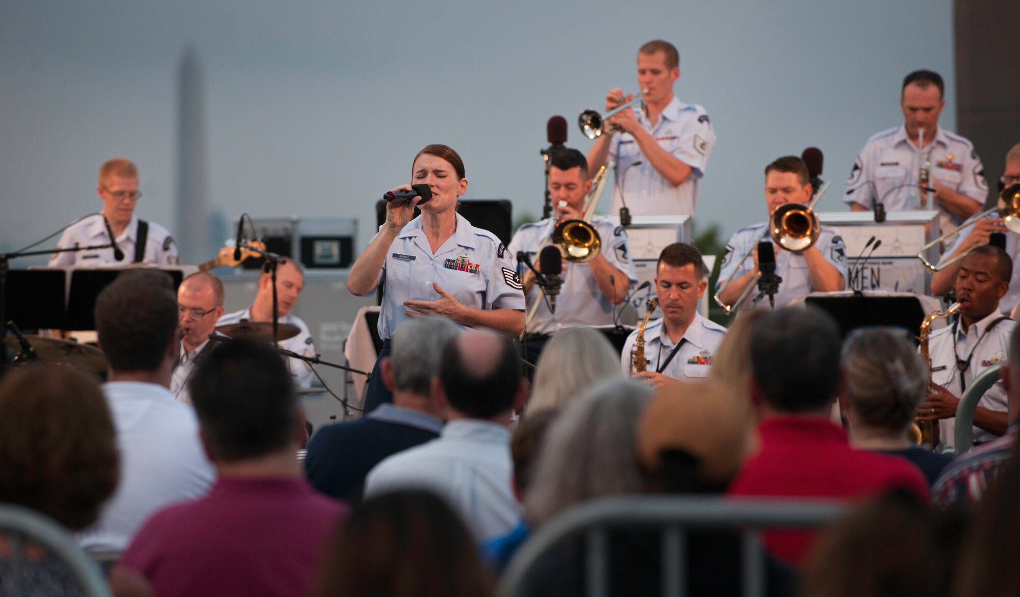 Tech. Sgt. Paige Wroble, U.S. Air Force Band’s Airmen of Note vocalist, sings during a concert at the U.S. Air Force Memorial in Arlington, Va., before the fireworks celebration in Washington, D.C., July 4, 2015.  The concert at the U.S. Air Force Memorial is an annual event that ends just before fireworks begin. (U.S. Air Force photo/Airman 1st Class Philip Bryant)
